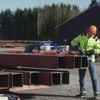 Man with construction helmet working on steel beams